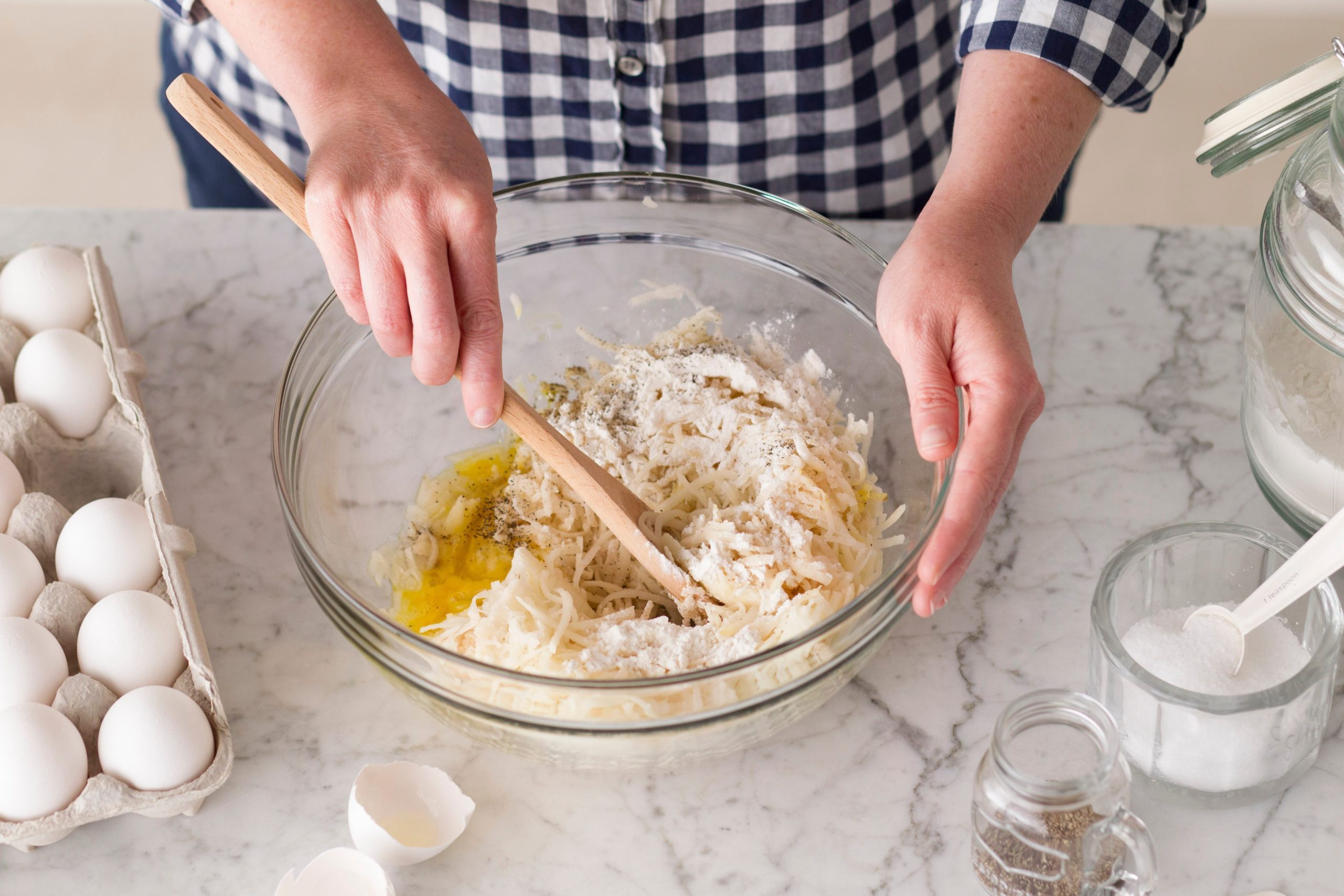Using a wooden spoon, all of the ingredients are mixed together in a glass bowl