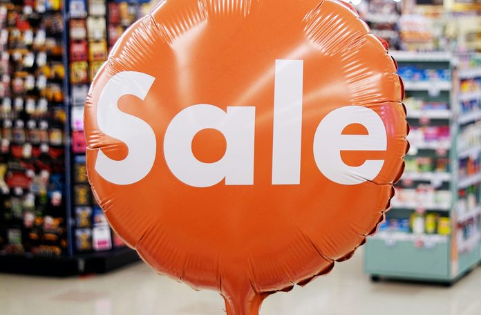 Orange sale sign in grocery store