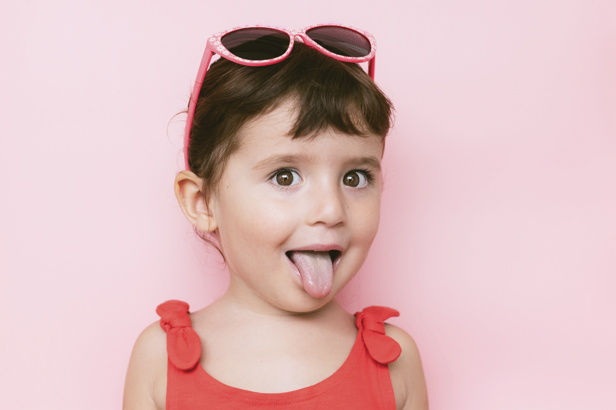 Child with colors dancing off tongue