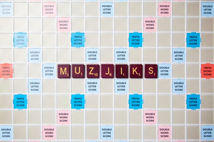 scrabble board with tiles that spell out muzjiks