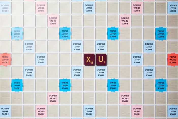 scrabble board with tiles that spell out xu