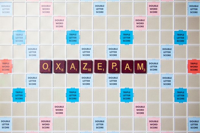 scrabble board with tiles that spell out oxazepam