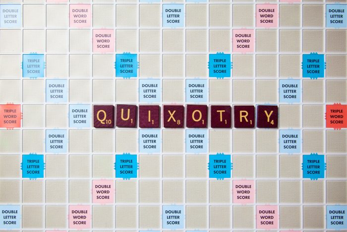 scrabble board with tiles that spell out quixotry