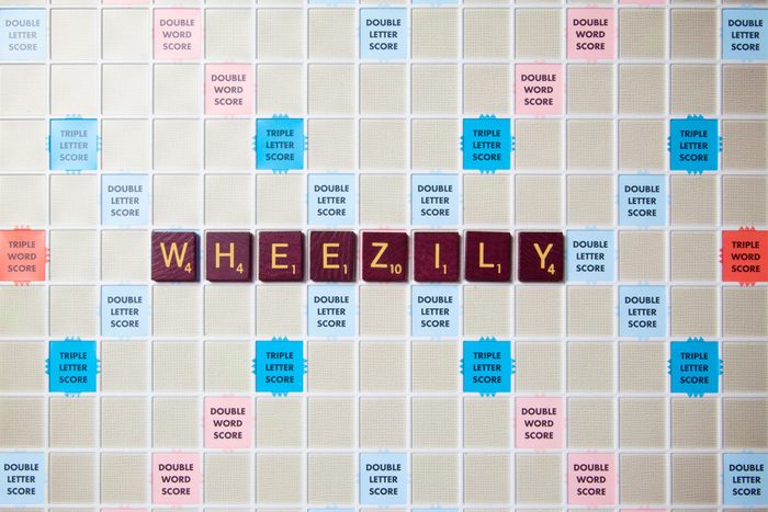 scrabble board with tiles that spell out wheezily