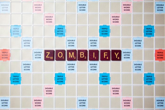 scrabble board with tiles that spell out zombify