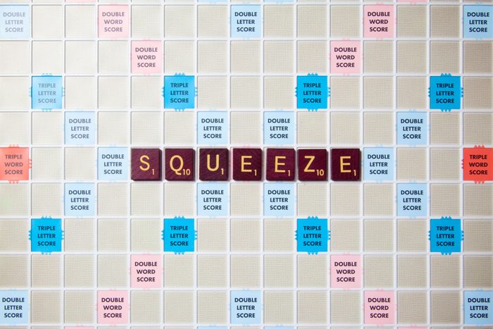 scrabble board with tiles that spell out squeeze