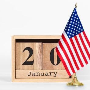 a perpetual calendar reads January 20 next to an American flag