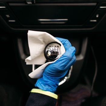 Wiping down gear shift lever in a car