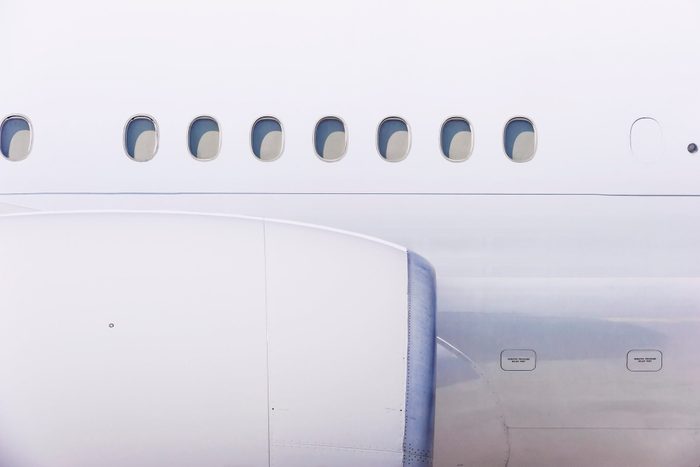 close up of engine and windows on airplane