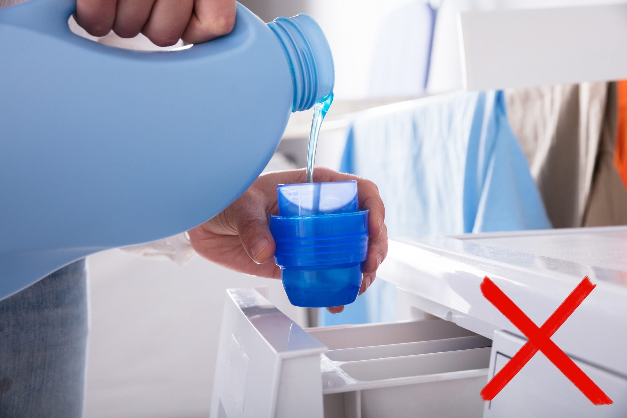 Pouring detergent into laundry