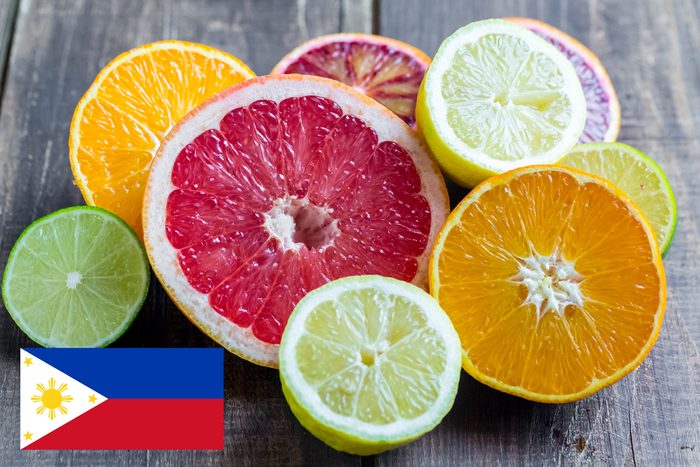 citrus fruits on wood table with philippines flag