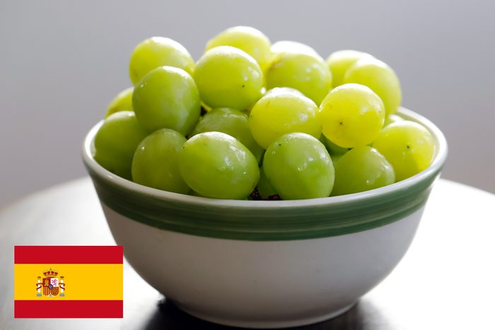 spain flag with a bowl of grapes