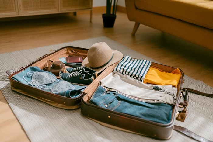 Travel Suitcase Opened with clothes in it