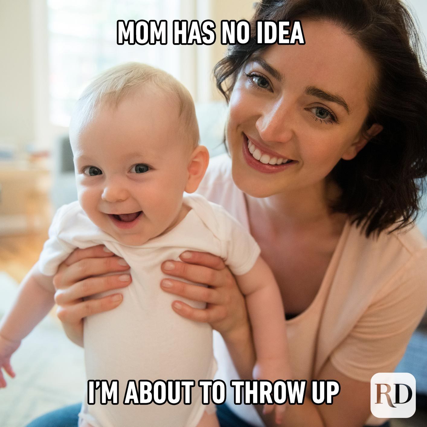 Mother holding baby, both smiling. Meme text: Mom has no idea I’m about to throw up.