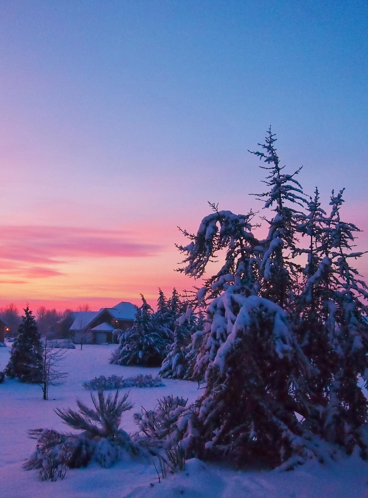 a vibrant sunset over a landscape covered in snow