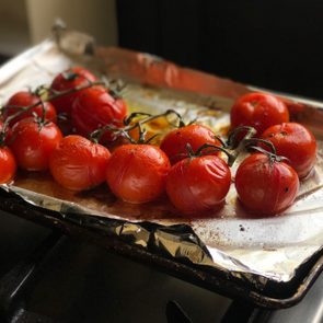 high angle view of roasted tomatoes on a pan lined with aluminum foil
