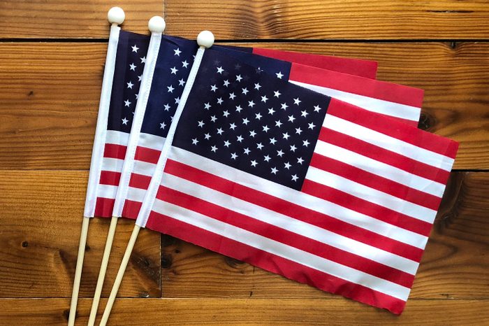American US small flags on wooden background