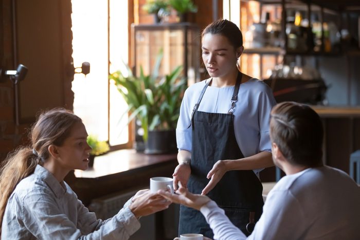 Angry client couple complain about bad service to waitress
