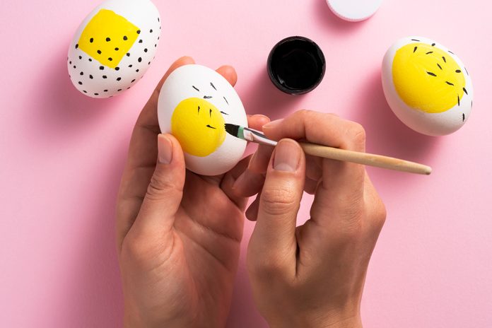 Painting easter eggs with a large yellow spot on each