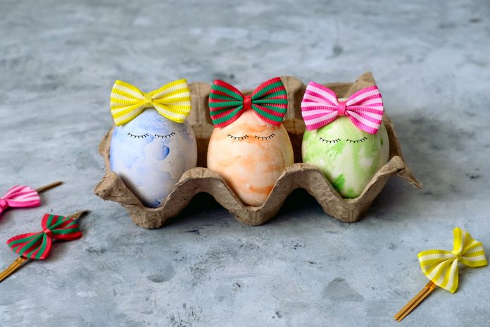 cute blue,orange and green Easter eggs in funny bows