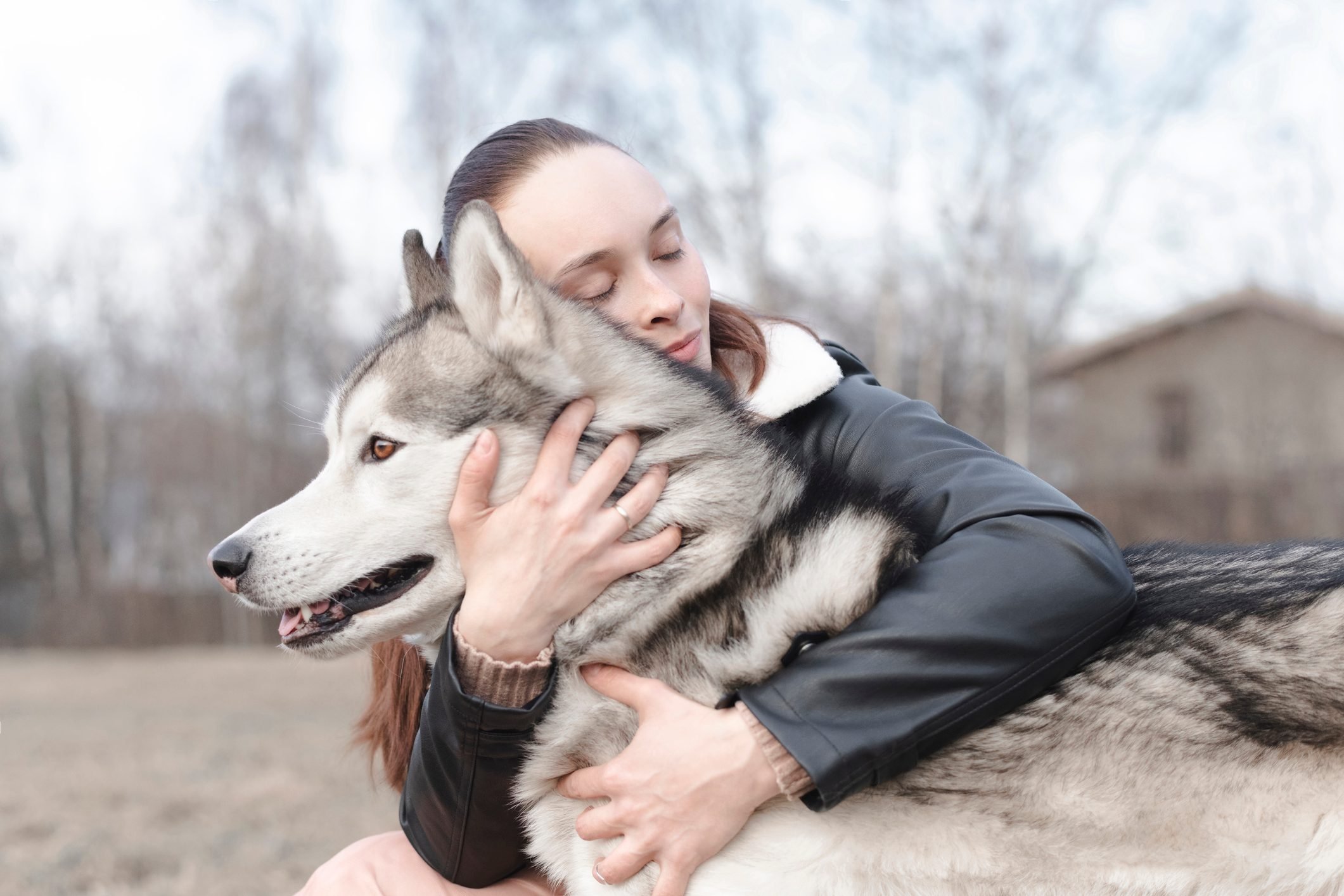 Happy woman cuddling her dog