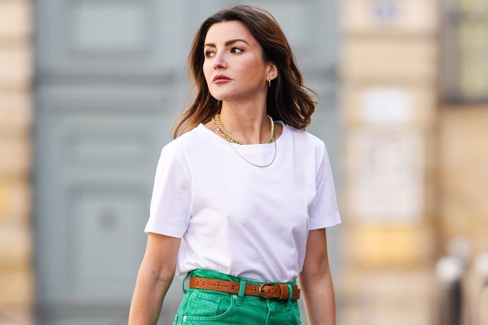woman wearing a white tshirt and green pants