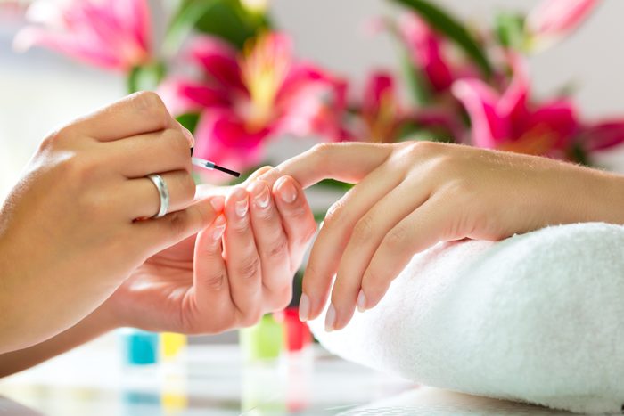 Woman in a nail salon receiving a manicure