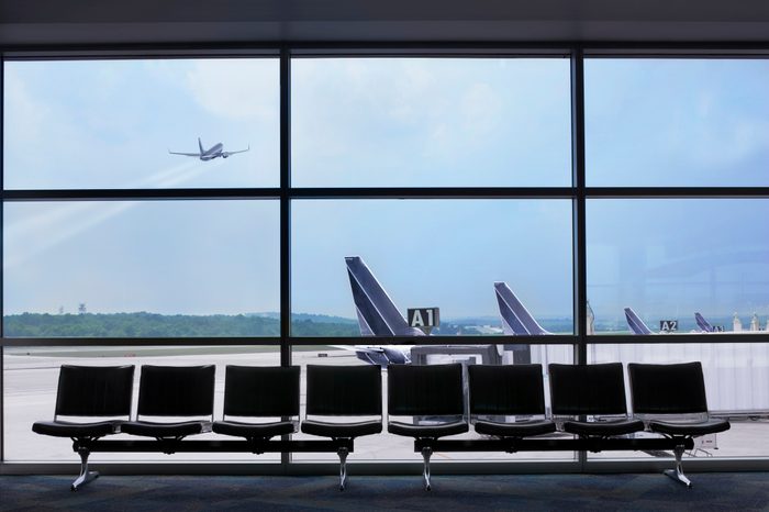 Airport waiting area, airplane taking off out the window