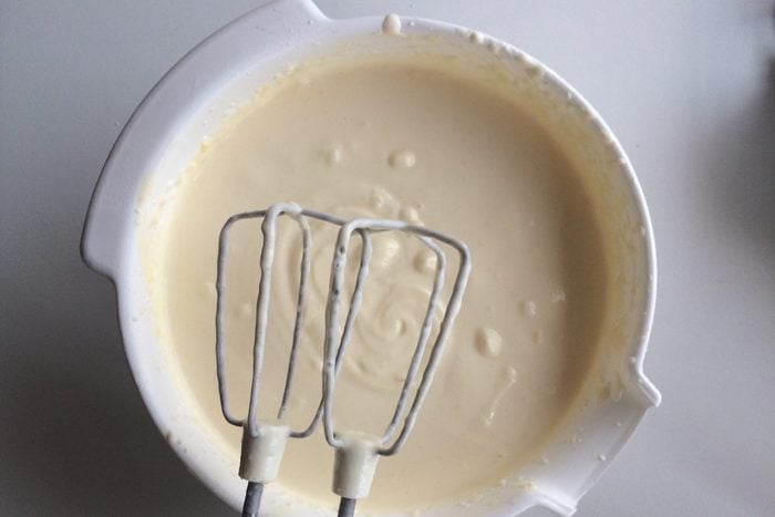 Close-up of a bowl of batter with hand mixer