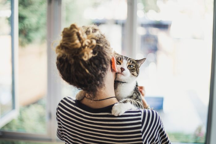 A teenager girl holding her cat