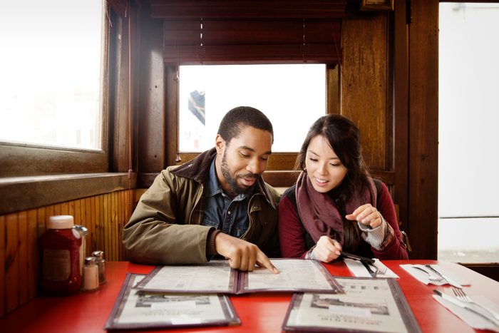 Couple looking at menu while sitting in restaurant
