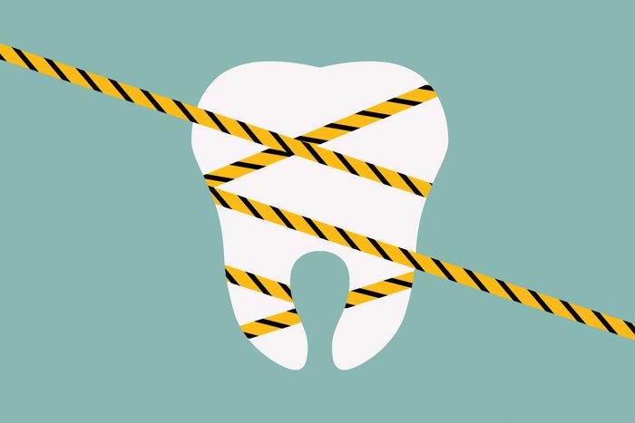 illustrated tooth wrapped with caution tape