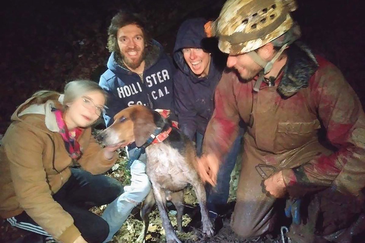 dog with his rescuers