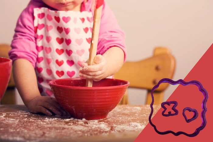child baking cookies for valentines day