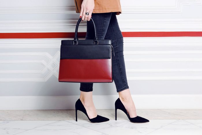 Close Up Legs Fashion Woman In Heel Shoes With Big Handbag