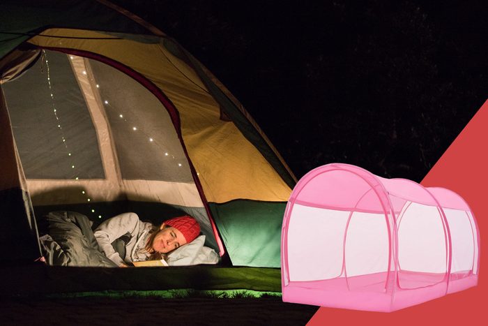 woman sleeping in tent in backyard