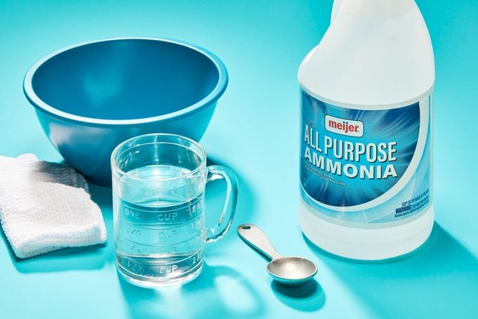 Supplies for ammonia solution for cleaning blood stains from carpet on blue background