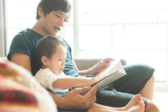 A father who reads a picture book for his son