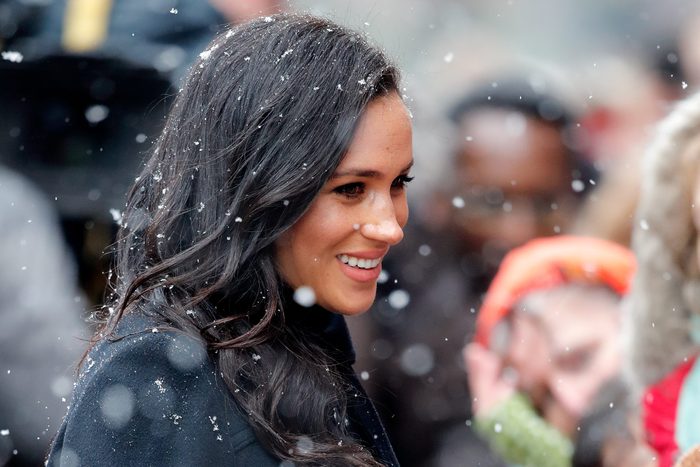 Meghan Markle in a crowd with snow falling