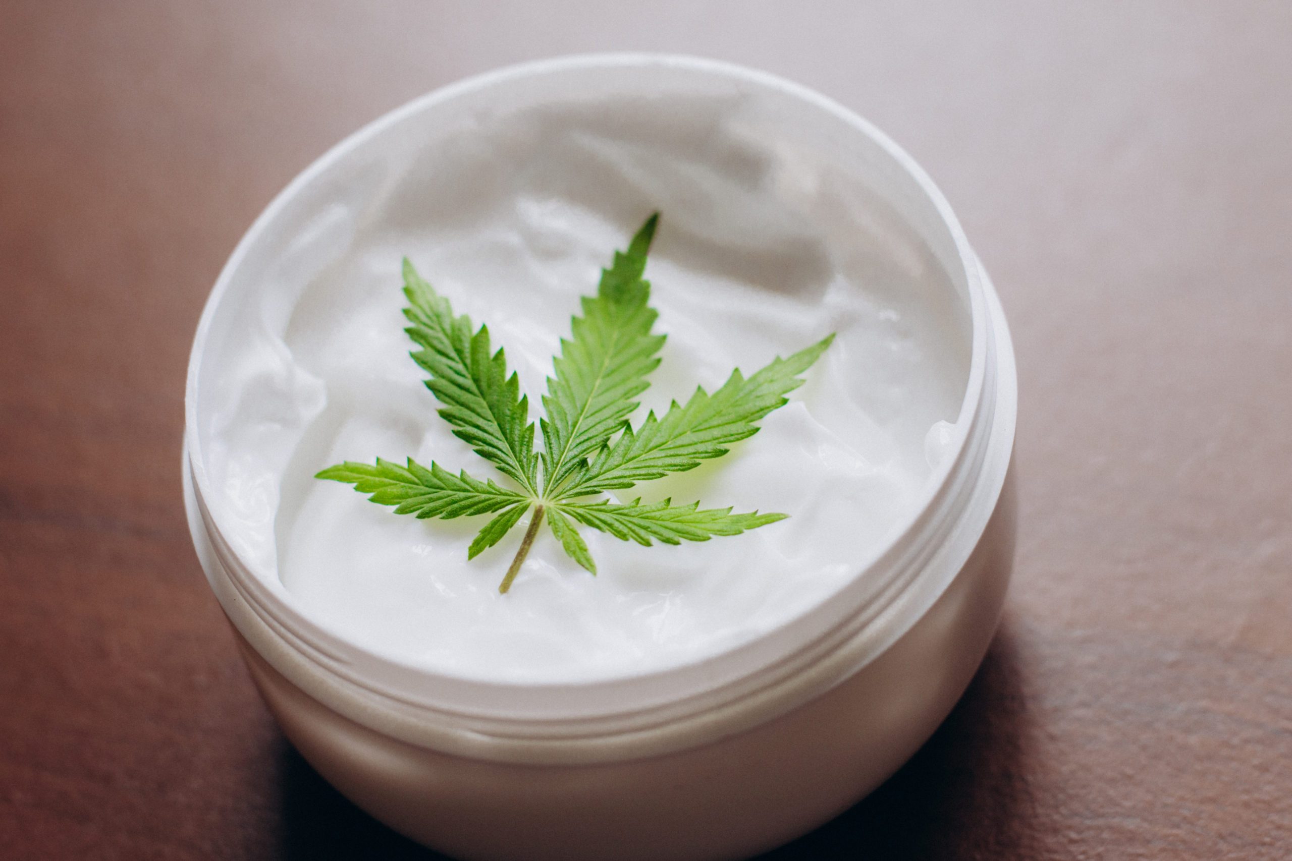 Cosmetic cream made of natural cannabis, hemp, moisturizing lotion with CBD content. Copy space for your design use,text