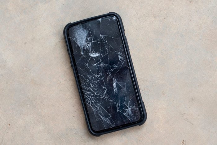 The phone screen is cracked.