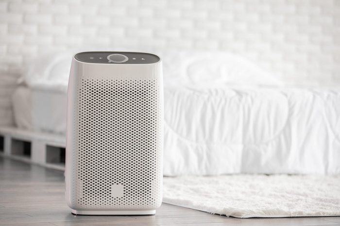 Air Purifier In Cozy White Bed Room For Filter And Cleaning Removing Dust Pm2 5 Hepa In Homefor Fresh Air And Healthy Lifeair Pollution Concept