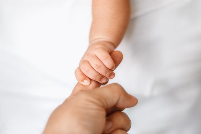 Newborn Baby Holding Adult Finger