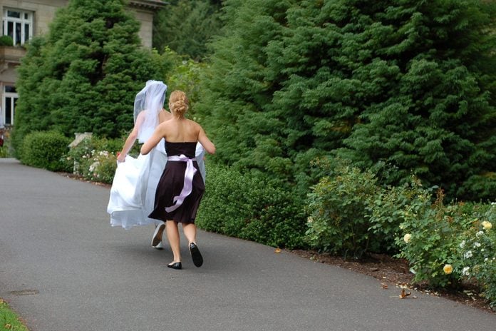 A bride running with her bridesmaid