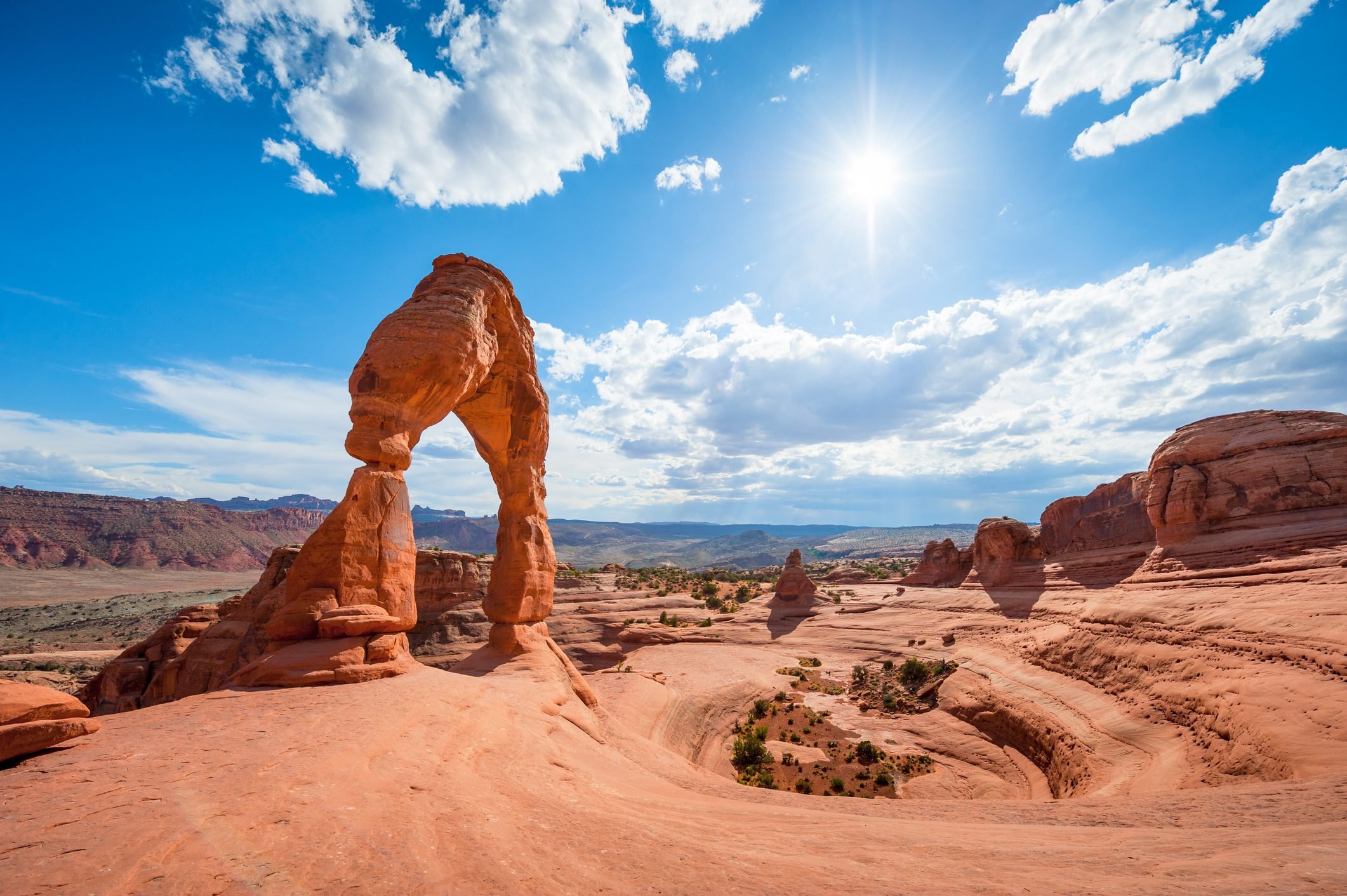 Delicate Arch at Arches National Park with sun shining in the sky near Moab, Utah