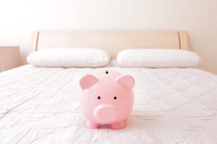 pink piggy bank on a hotel bed
