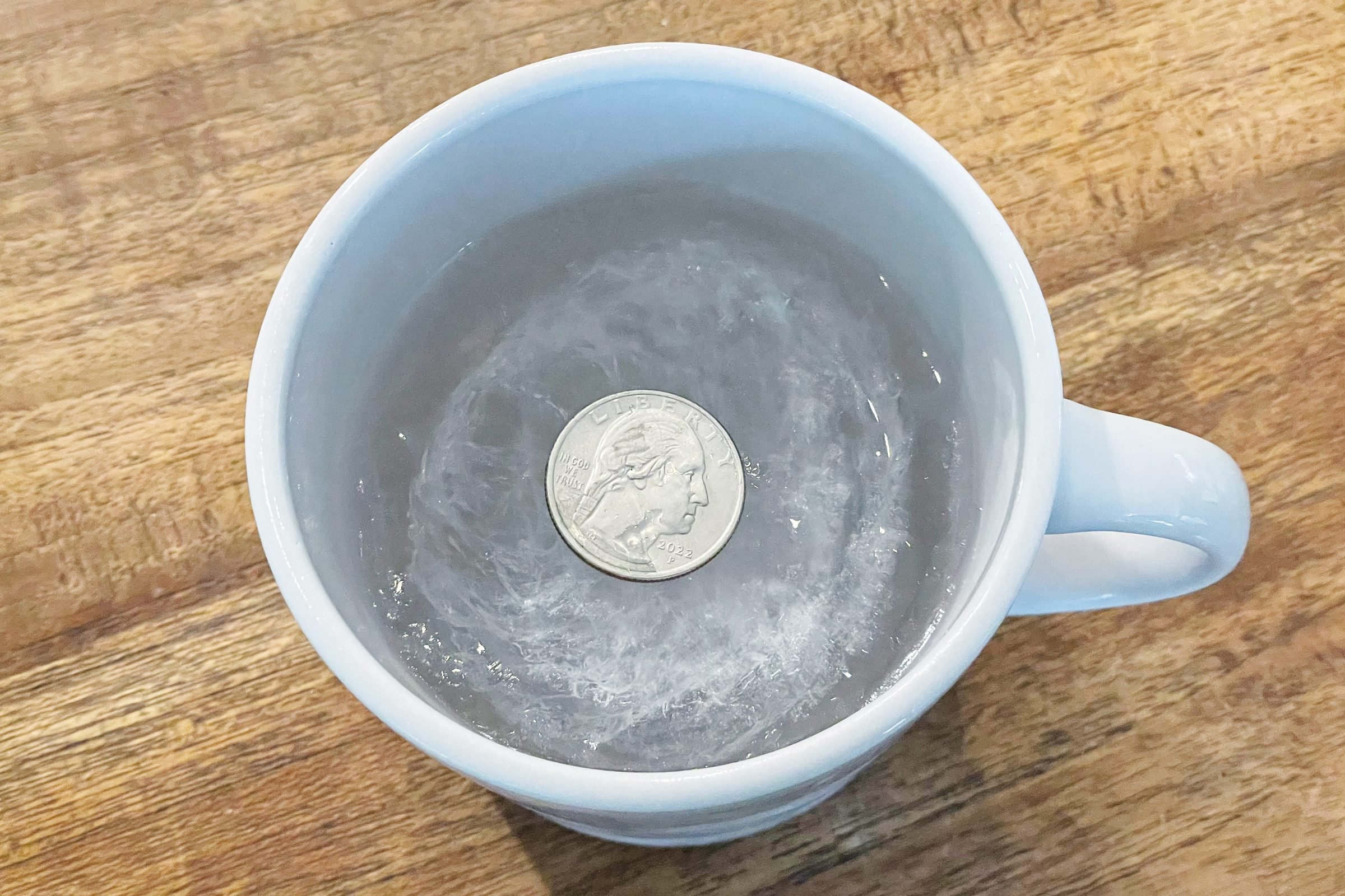 Can a Quarter on a Frozen Cup of Water Actually Determine Food
