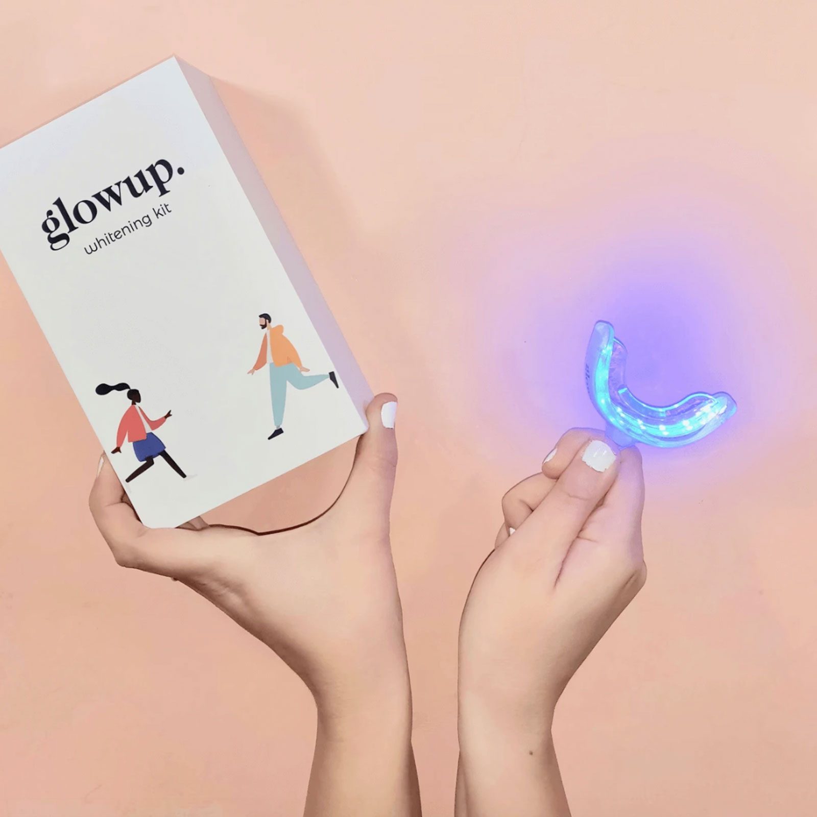 Hands holding a box and tooth whitening set