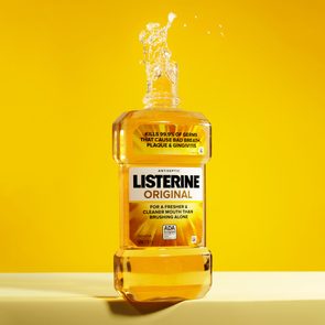 bottle of yellow listerine on yellow background