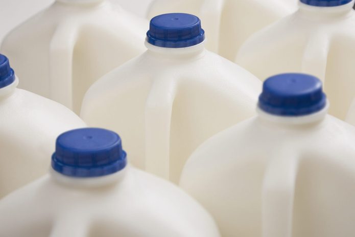 Several plastic containers of milk